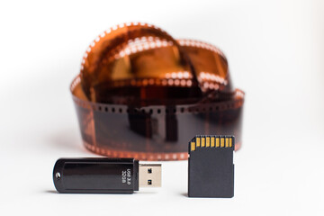 modern sd and usb flash card on vintage 35mm film background, concept of saving information at...