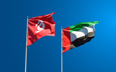 Beautiful national state flags of Tunisia and UAE United Arab Emirates together at the sky background. 3D artwork concept.