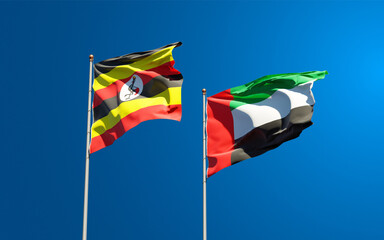 Beautiful national state flags of Uganda and UAE United Arab Emirates together at the sky background. 3D artwork concept.