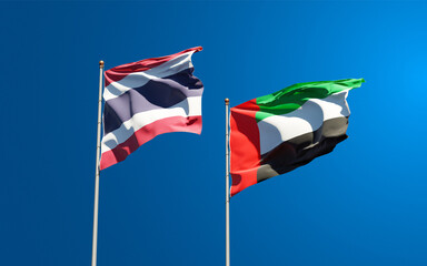 Beautiful national state flags of Thailand and UAE United Arab Emirates together at the sky background. 3D artwork concept.