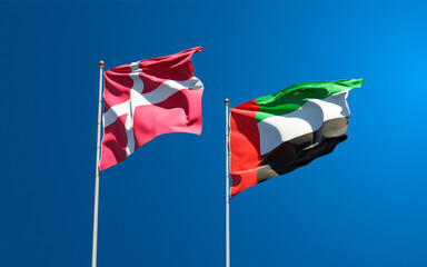 Beautiful national state flags of Denmark and UAE United Arab Emirates together at the sky background. 3D artwork concept.