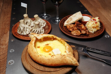 business lunch of khachapuri, khinkali and barbecue with a side dish