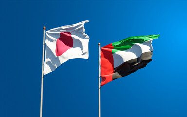Beautiful national state flags of Japan and UAE United Arab Emirates together at the sky background. 3D artwork concept.