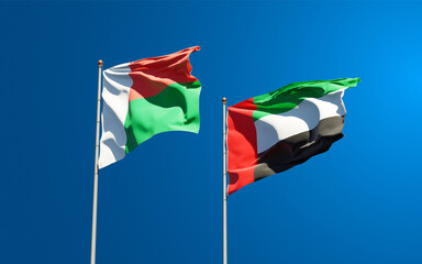 Beautiful national state flags of Madagascar and UAE United Arab Emirates together at the sky background. 3D artwork concept.