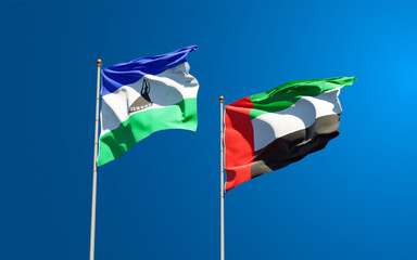 Beautiful national state flags of Lesotho and UAE United Arab Emirates together at the sky background. 3D artwork concept.