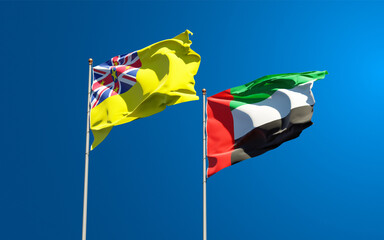 Beautiful national state flags of Niue and UAE United Arab Emirates together at the sky background. 3D artwork concept.