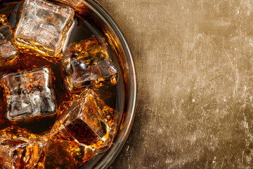 Glass of alcohol coctail or cola with ice cubes