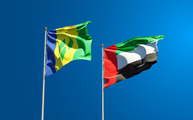 Beautiful national state flags of Saint Vincent and the Grenadines and UAE United Arab Emirates together at the sky background. 3D artwork concept.