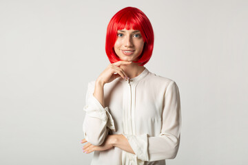 beautiful young female with red hair in a white shirt