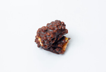 A pile of milk and nuts chocolate isolated on a white background