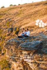 couple with kids on top of hill