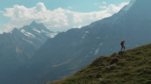 Aerial drone shot of tourist hiking in the swiss alps in Switzerland