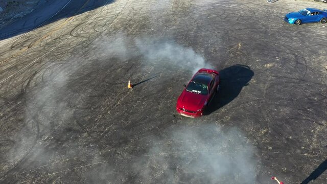 Done shot of muscle and sports cars doing doughnuts and burnouts with a car club in the Angeles National Forest in Southern California