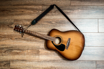 acoustic guitar hanging on the wall