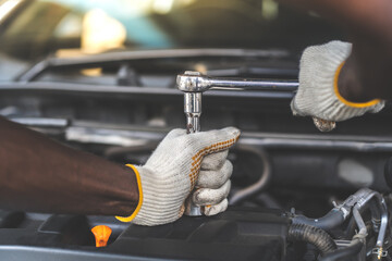 Hands Expertise car mechanic in auto repair service. Car maintenance and auto service garage...