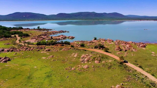 Aerial of African landscape with a car on the road Gaborone dam in Botswana 