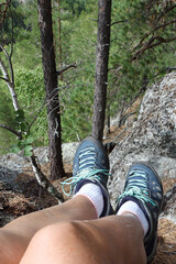 Women's feet in trekking boots on  top of a mountain, Altai Mountains, Russia