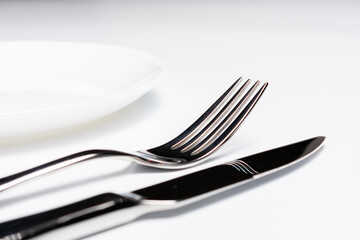 Knife, plate and fork, isolated on white