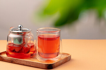 Glass teapot and cup with black tea