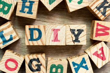 Fototapeta na wymiar Alphabet letter block in word DIY (abbreviation of do it yourself) with another on wood background