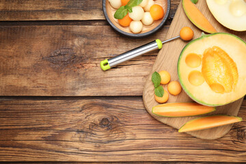 Flat lay composition with melon balls on wooden table, space for text
