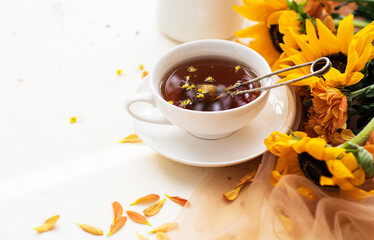 Autumn, fall leaves, flowers hot cup of herbal tea on wooden rustic background. Seasonal, morning...