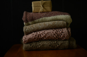 a pile of knitted sweaters