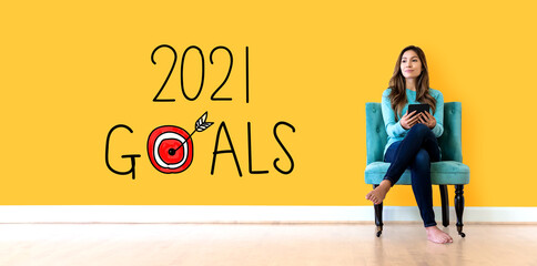 2021 goals concept with young woman holding a tablet computer