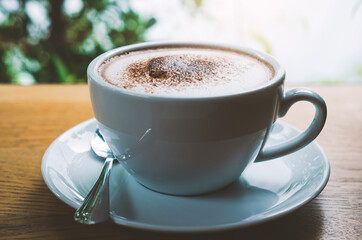 closeup coffee cup on wood table bar in restaurant or cafe with copy space. fresh beverage.