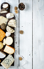 Various types of cheese with empty space background concept. On a white wooden background.