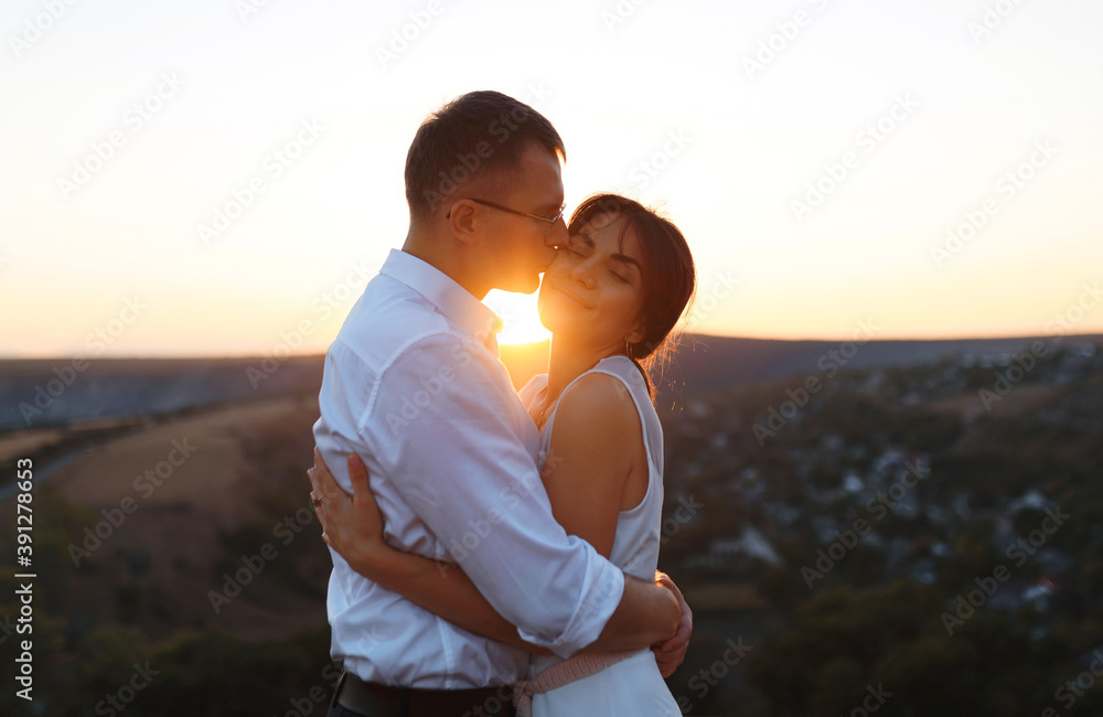 Poster man kissing woman in cheek on hill