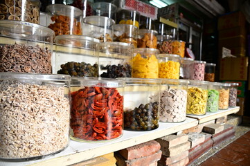 A local store at Dihua Street in Taipei, Taiwan sells traditional Taiwanese snacks in glass jars with stickers 
