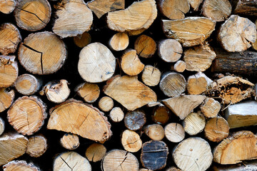 The texture of a stack of chopped firewood, close-up.