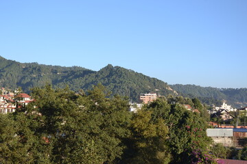 Fototapeta na wymiar forest, hills, blue sky, green trees and beautiful landscape. Pictured in Kathmandu valley, Nepal.