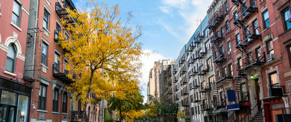 Panoramic view of historic buildings along 15th Street with colorful fall trees in the Chelsea neighborhood of New York City