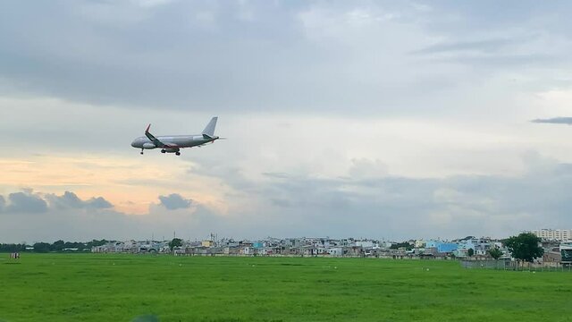 Airbus A330 takes off and fly over urban areas preparing landing into Tan Son Nhat International Airport