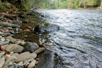 Fototapeta na wymiar Low angle of Oconaluftee river running along side a hiking path in Smoky mountains national park 