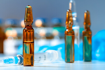 Vial of vaccine bottle with a syringe close up