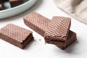 Delicious chocolate wafers on white table, closeup