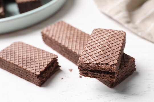 Delicious chocolate wafers on white table, closeup