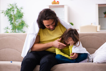 Small girl looking after her sick father