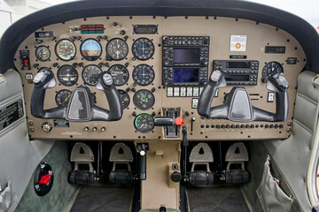 Detail of the cockpit of the old plane. Aircraft equipment, various indicators, buttons, instrument pedals. Aircraft instrument panel at the pilot school.
