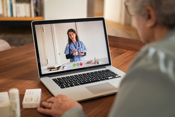 Senior woman in video tele medicine call with doctor - obrazy, fototapety, plakaty