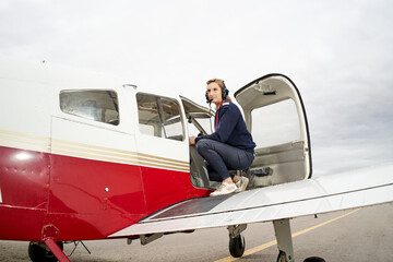 Female pilot preparing to get into her plane.