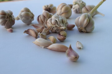 peeled garlic on white background