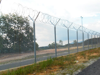 Fototapeta na wymiar MELAKA, MALAYSIA -JUNE 5, 2020: Anti-climb fencing made from galvanized iron install at the perimeter or property boundary to prevent from the intruder. Its close nets can prevent intruders from climb