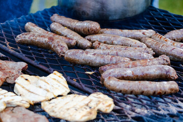 Close up image of traditional boerewors /' sausage on a braai/bbq in South Africa on an open fire