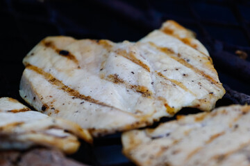 Close up image of traditional chicken fillet on a braai/bbq in South Africa on an open fire