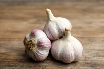 Fresh organic garlic on wooden table, closeup