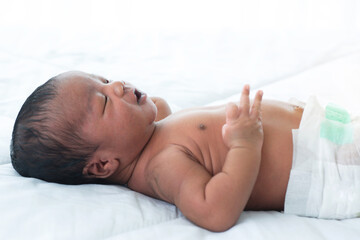Obraz na płótnie Canvas Cute mixed race baby, 17 days old, sleeps on a blanket, selective focus
